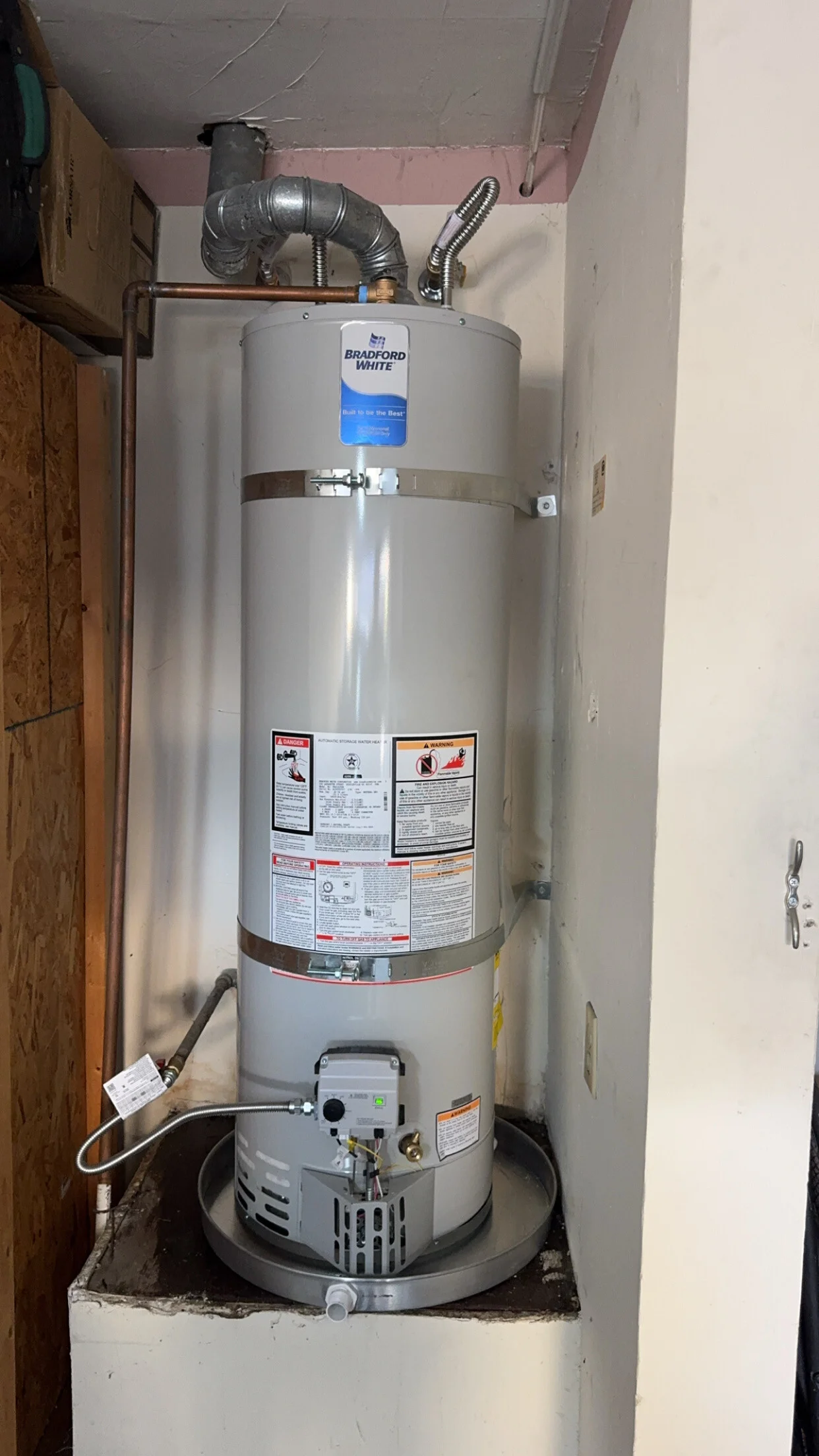 Water heater safety inspection showing T&P drain and seismic strapping